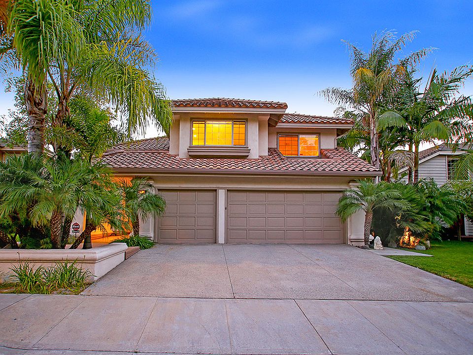 Plenty of parking in your 3-car garage. Enjoy the tropical feel w/ palms