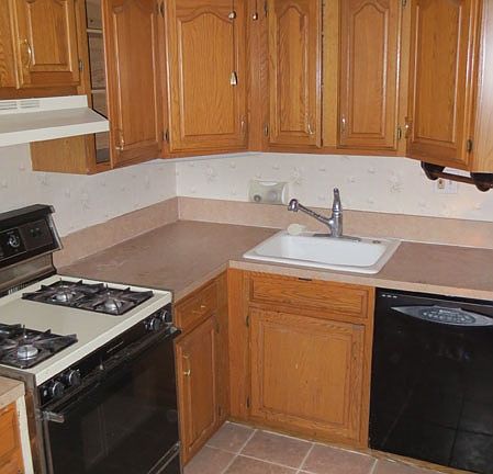 Kitchen with dishwasher, stove, and fridge
