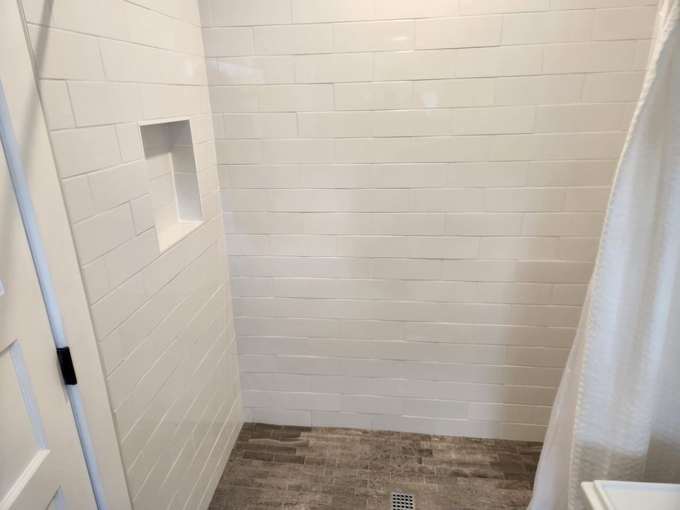 Subway tiled shower is clean and inviting.