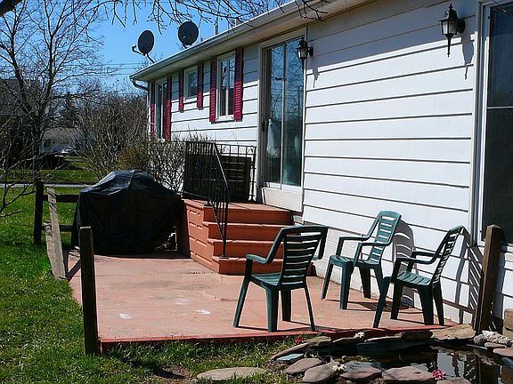 rear patio with sliding door access and small pond