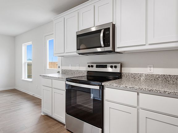 The kitchen of the Reed has beautiful, white wood cabinets.