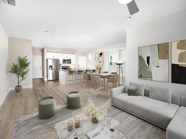 An open, light-filled layout at Amavi Kissimmee offers generous space to gather, with a seamless flow from kitchen to living area and views of your private yard.