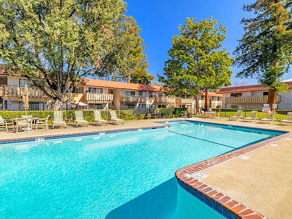 Refreshing poolside living, surrounded by lush landscaping.