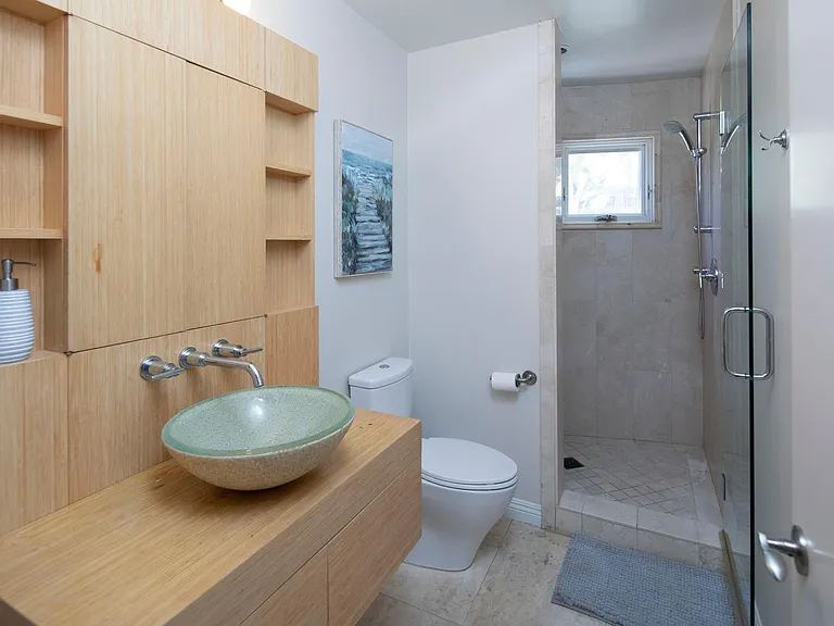Secondary bathroom right off the front entrance and neighboring the secondary bedroom