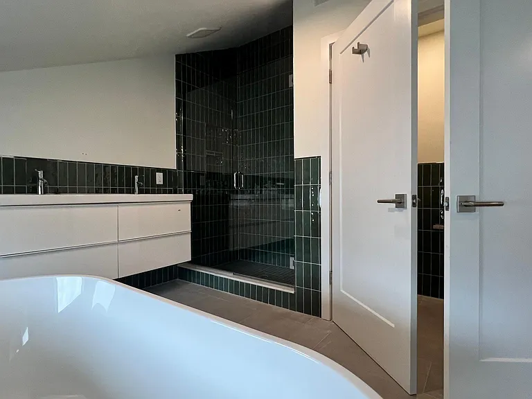 Deluxe Bathroom with soaking tub, walk in shower, double vanity and water closet.