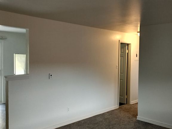 Living room opens to hall and kitchen