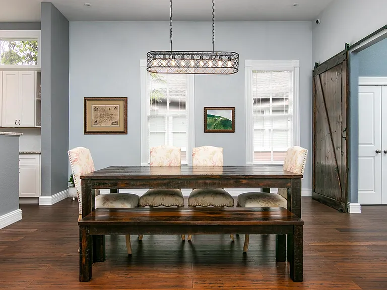 Large dining room opens to the kitchen for a modern open concept in this vintage home w/soaring ceilings.