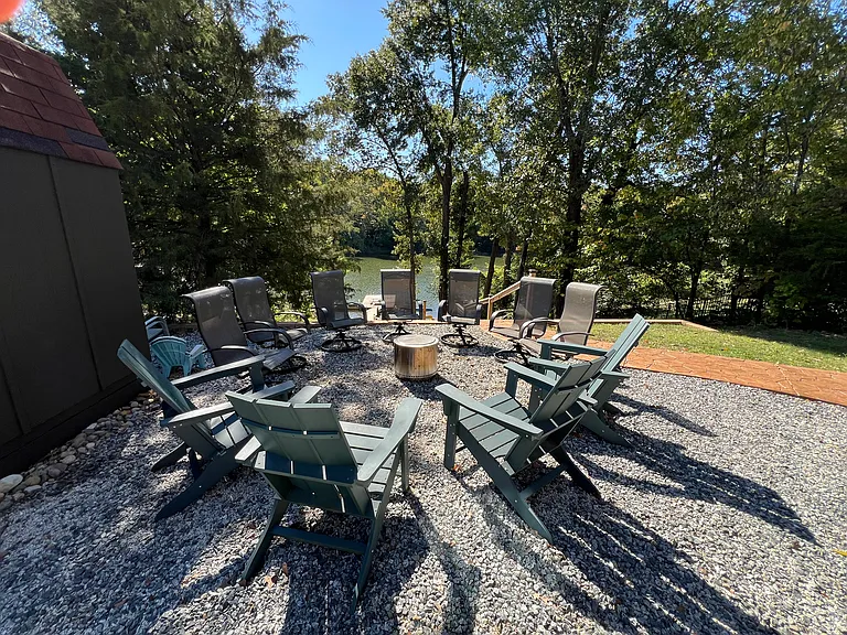 Gravel fire pit area adjacent to lower level cement patio. Includes solo stove.