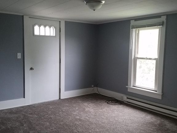 Living room with balcony access, fresh paint, & new carpet