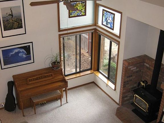 Living room with vaulted ceilings and wood stove