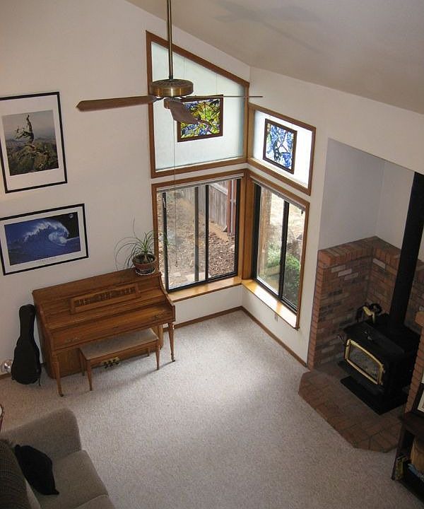 Living room with vaulted ceilings and wood stove