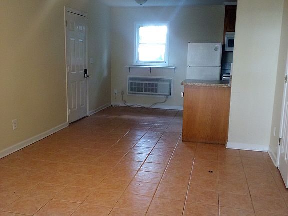 View upon entry (ground floor). Living room. Partial view of kitchen.