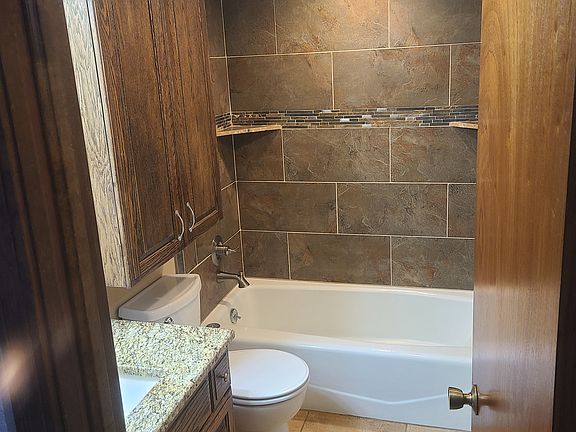 Main Bathroom, Granet countertops, tile on floor and in shower. Lots of storage. Shower and bathtub.