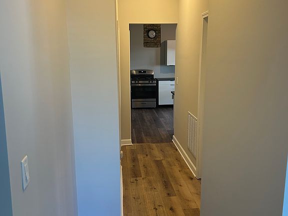 Front hallway from living room to kitchen and first two bedrooms.