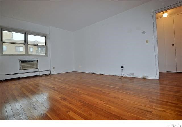 Living Room has refinished hardwood floors and an opening to the kitchen