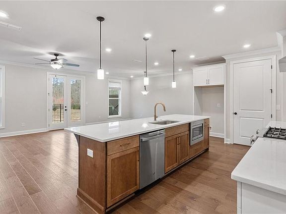 Overly sized kitchen island overlooks living and dining open concept on main floor