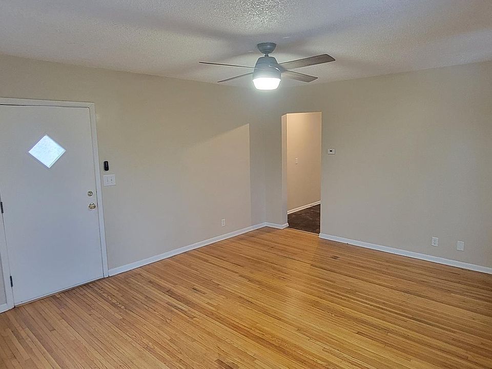 Large living room with ceiling fan/light on remote.