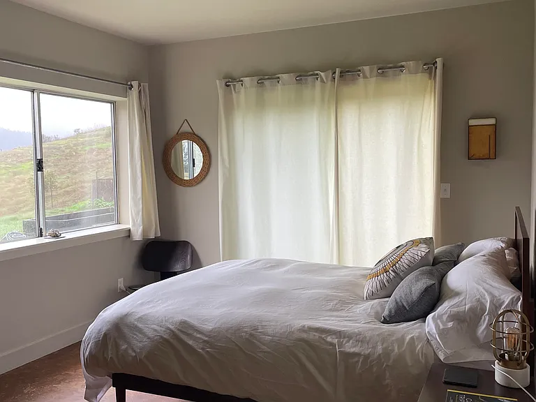 Downstairs Queen. Sliding door to garden patio and views.