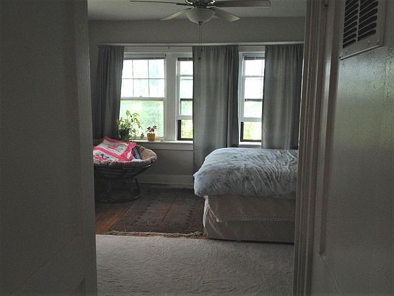 Front room with bed and furniture for idea of size.