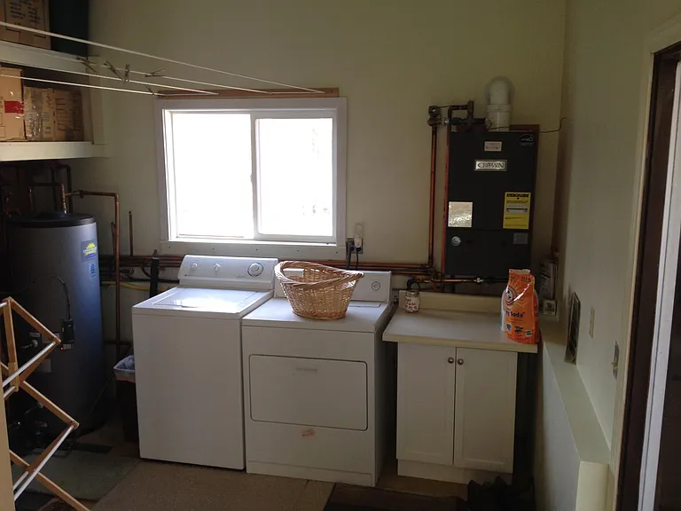 Shared laundry rm with high storage shelves, dry racks + clothes lines, plus large clothes lines outside back door. Brand new high efficiency natural gas boiler.