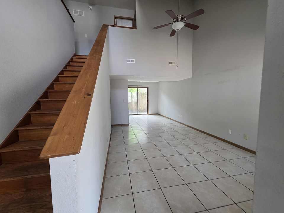 large open living room and dining area with vaulted ceiling