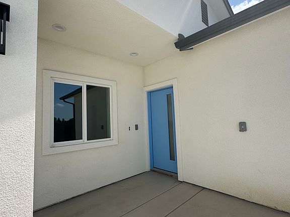 Front door and adjacent bedroom or office facing the front of house.