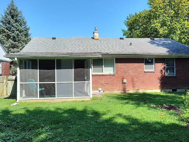 Back of home with screened porch