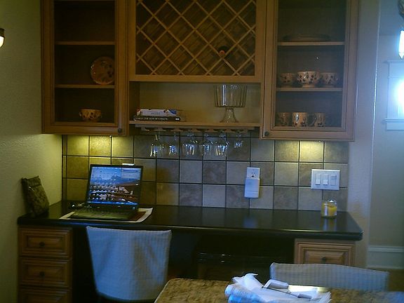 The kitchen has a beautiful display cabinet area.