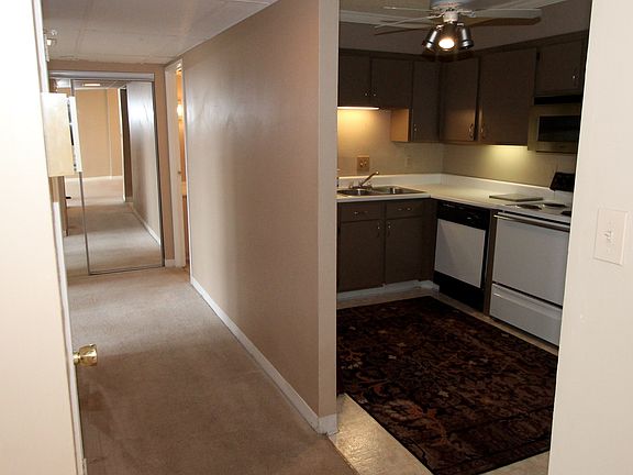 Hallway leading to kitchen and full hall bath on right and e