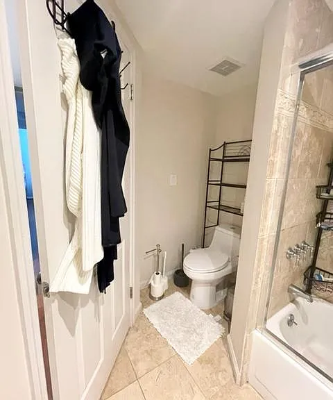 Bathroom toilet space. Has fan.