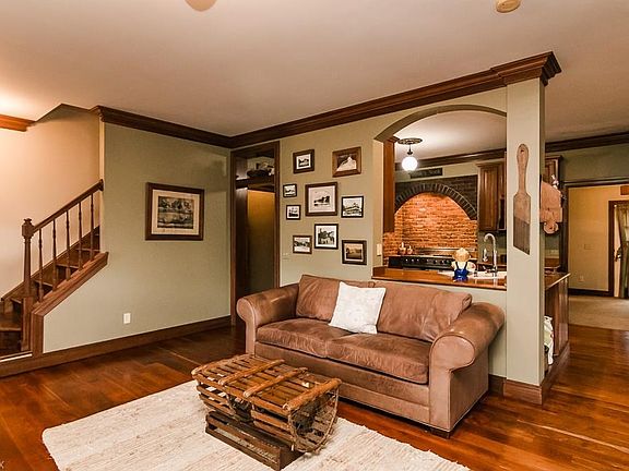 Living Room featuring wide plank, locally sourced cherry floors, gas fireplace (pictured behind photographer), 2 piece crown molding (hardwood), and 9 foot ceilings.