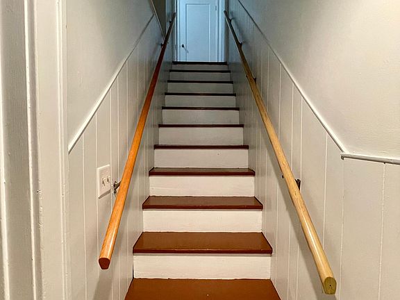 Stairway leading up to unit. Includes entryway cubby space. Separate entrance to the unit on the side of the house.