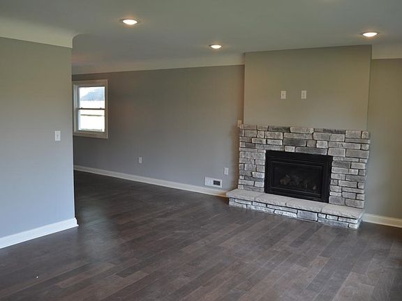 New gas fireplace with stone surround.