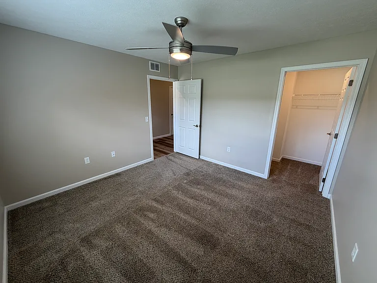 Guest bedroom with view of its own walk-in closet