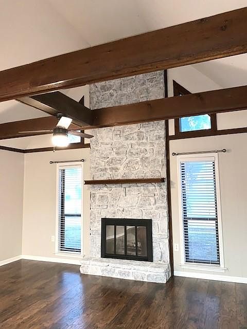 OPEN FLOOR PLAN! Living Room with NEW WOOD Laminate Flooring, Wood Burning Fireplace and Vaulted Ceiling with Wood Beams. NEW Ceiling Fan. Fresh Paint: Sherwin Williams Agreeable Grey