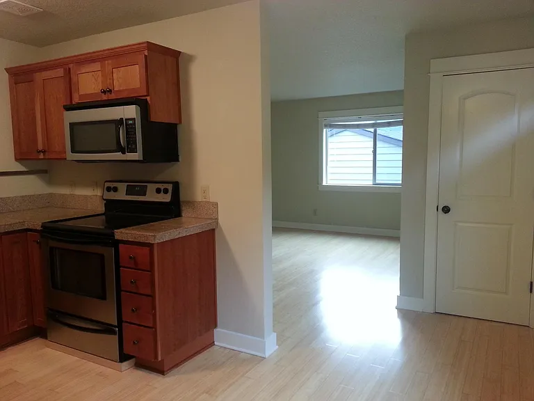 The kitchen opens up into the bright living room.