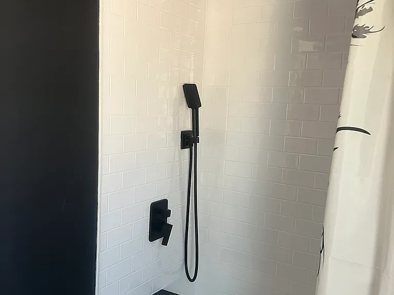 Brand new plumbing and fixtures! Rain shower and hand held. Shampoo, Conditioner and Body wash dispensers.