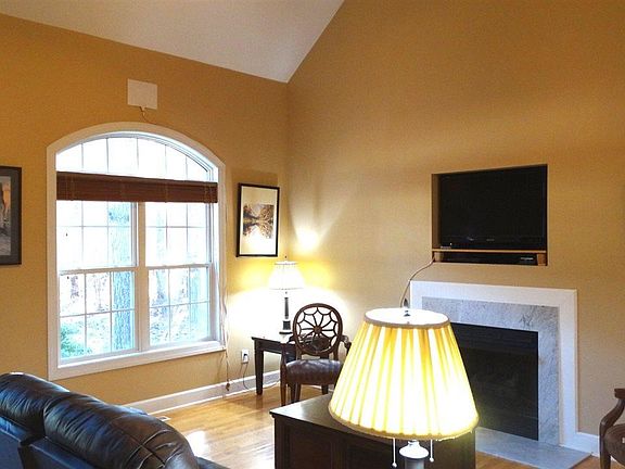 Tall ceilings, ceiling fan, window, light, bright and airy room! Hardwood floors