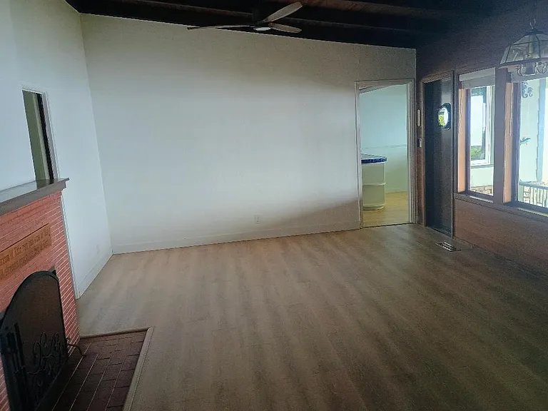 Living Room - Kitchen Door Is At Upper Right, Back Door To Patio Is Located To The Right Of Kitchen Door