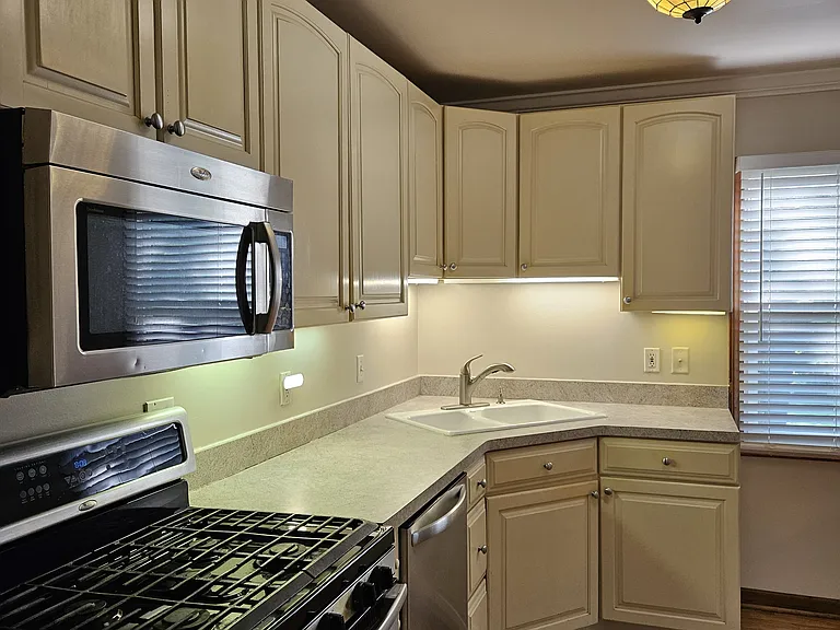 Kitchen w/ Under Cabinet Lights, Tiffany Ceiling Light and Windows w/ 2" White Blinds