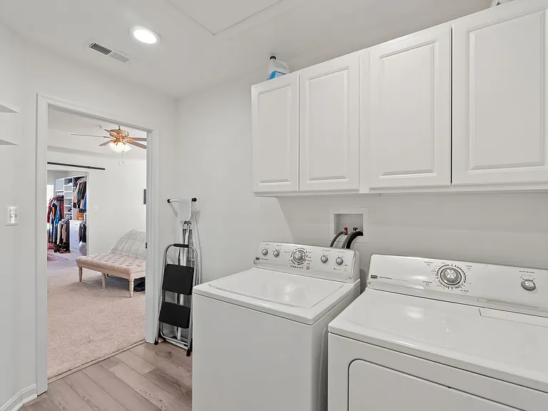 No more hauling laundry up and down stairs with the spacious upstairs laundry room, featuring built ins for added storage, a folding table and rod for hanging.
