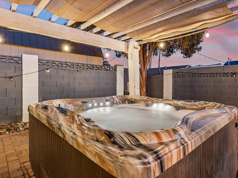 Relax and unwind in this cozy backyard jacuzzi