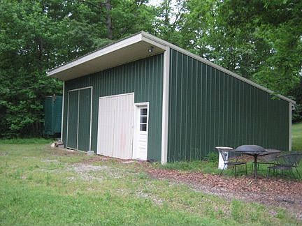 Storage shed with carport