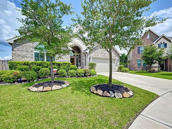 This beautiful yard is perfectly manicured and landscaped.