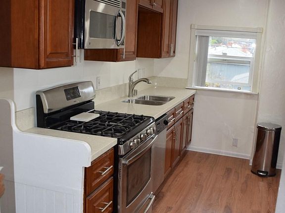LED lighting, quartz countertops, includes stainless appliances, dishwasher, gas stove, microwave and Kitchenaid Fridge