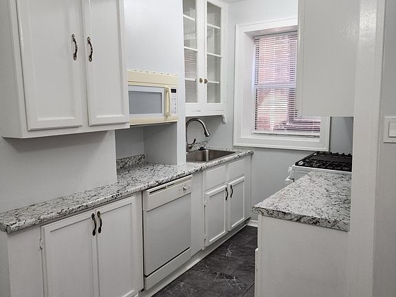 Other side of kitchen with Dishwasher, Stove, additional cabinets and counter space