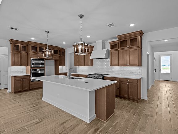 Kitchen features pendant lights over island
