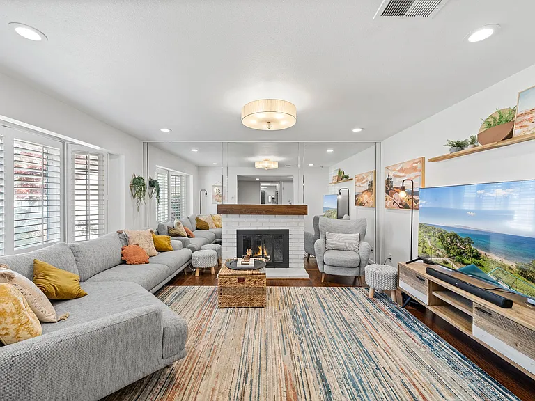 Living Room with dual pane windows & wood burning fireplace