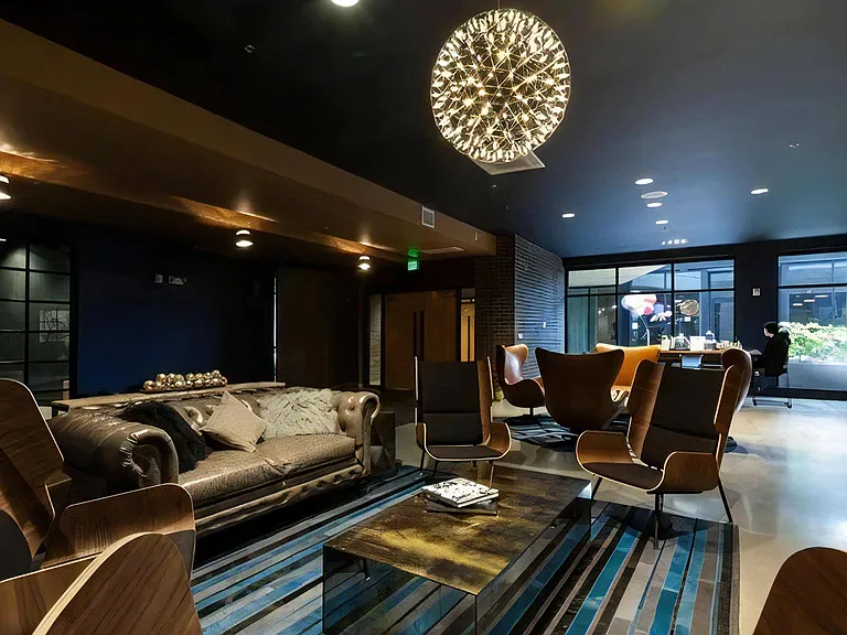 Community Lounge with Multiple Seating Areas and Overhead Lighting