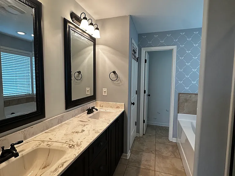 Primary bedroom bathroom, separate bath and shower. His and hers vanity,
